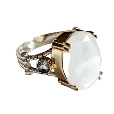 Oval cut moonstone cabochon with two small round topaz on either side ring with bezel setting set in 925 silver, size 9